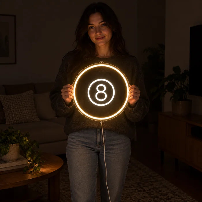 Black Eight Ball Neon LED Sign held by a woman, showing its size compared to her body