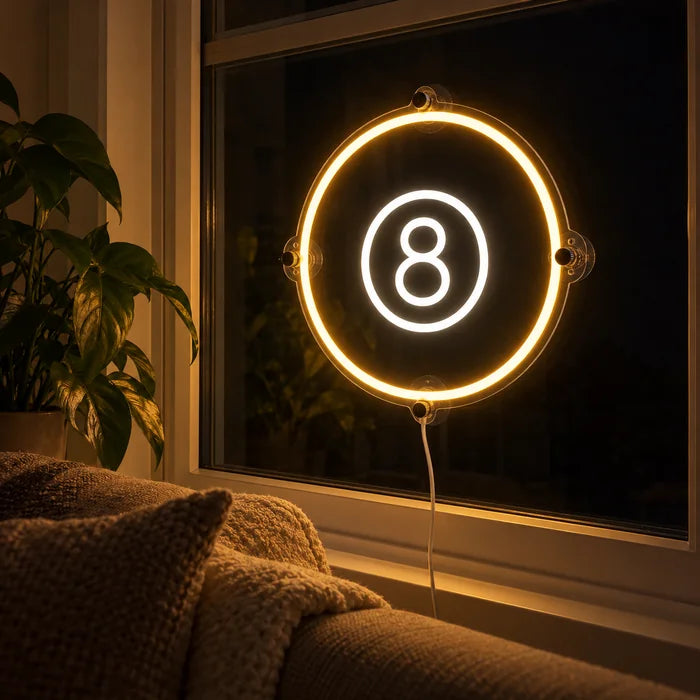 Black Eight Ball Neon LED Sign in the window of a cosy living room in the evening