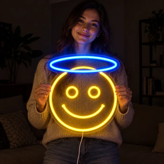 Angel Smiley Neon LED Sign held by a smiling woman against a dark background