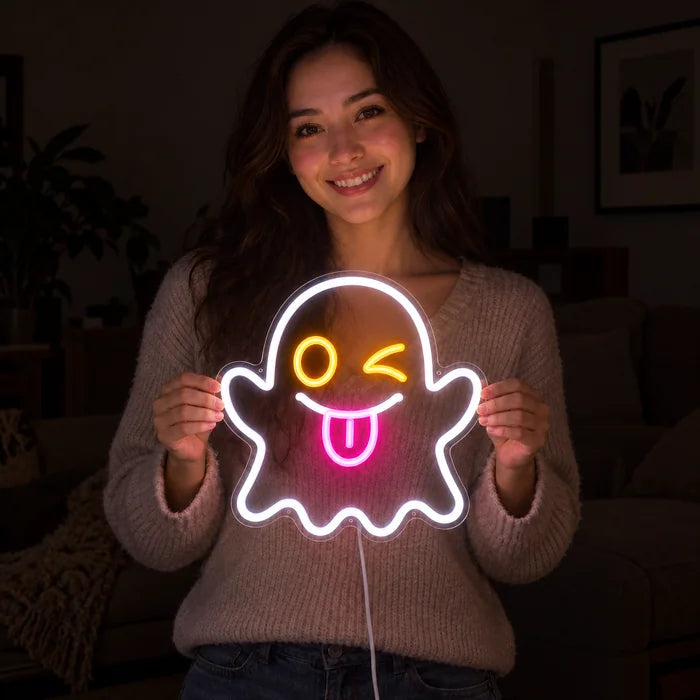 Cheeky Ghost Neon LED Sign held by a smiling woman against a dark background