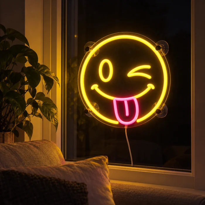 Cheeky Smiley Neon LED Sign in the window of a cosy living room in the evening