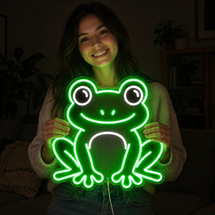 Frog Friend Neon LED Sign held by a smiling woman against a dark background