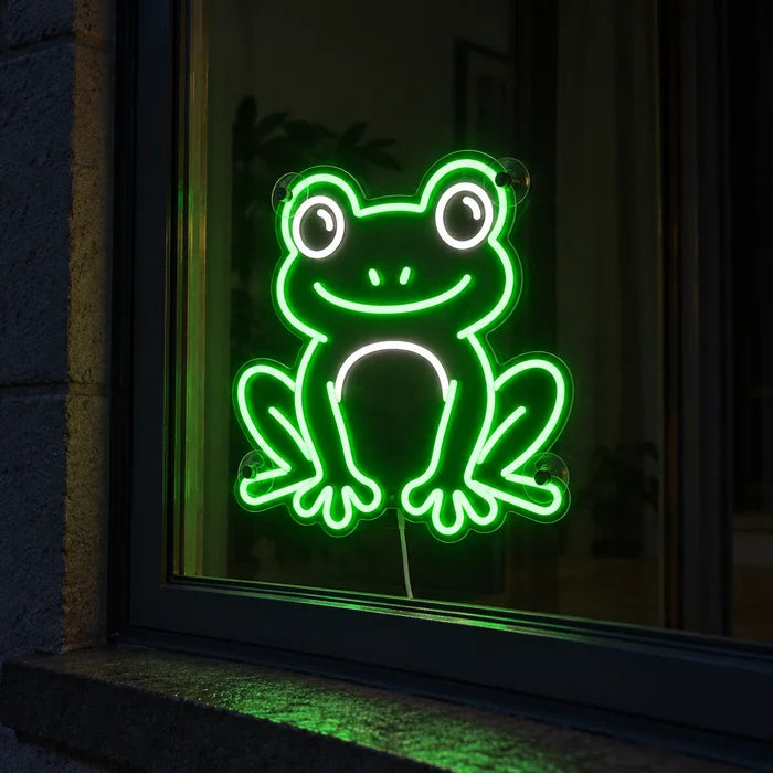 Frog Friend Neon LED Sign in a window, seen from the street at night