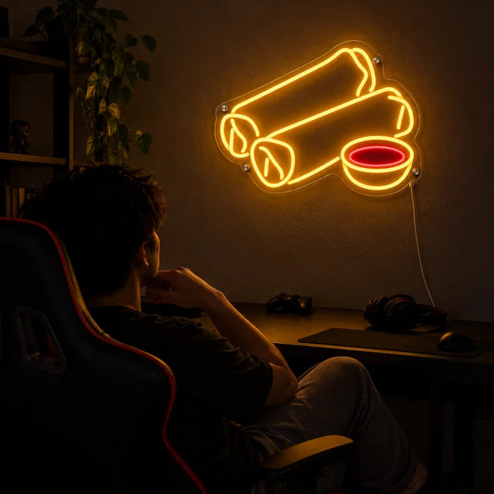 Spring Rolls Neon LED Sign above a gaming desk, a gamer in a gaming chair in front of it