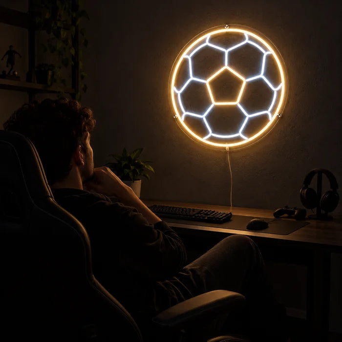 Football Neon LED Sign above a gaming desk, a gamer in a gaming chair in front of it