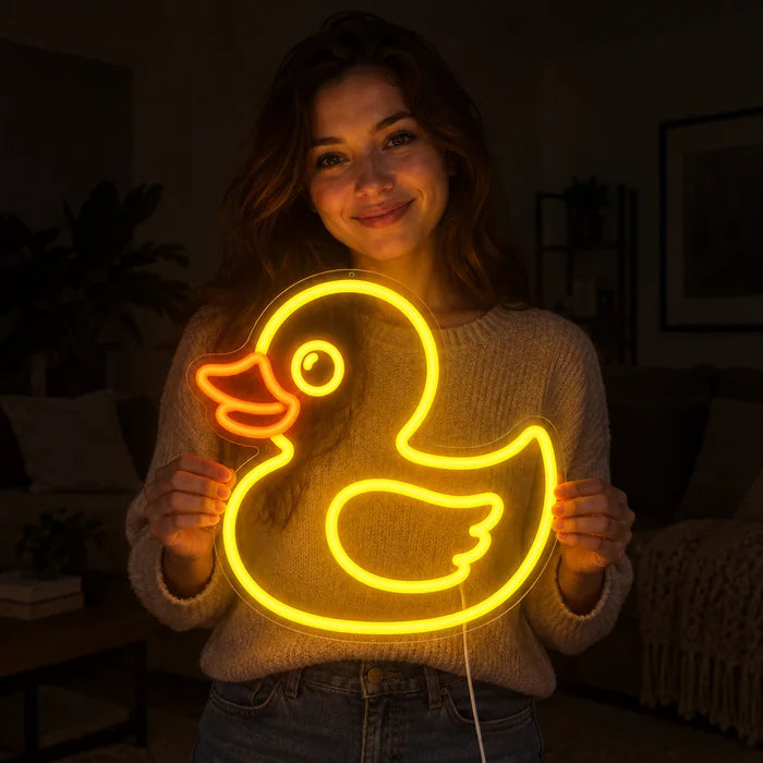 Yellow Duck Neon LED Sign held by a smiling woman against a dark background