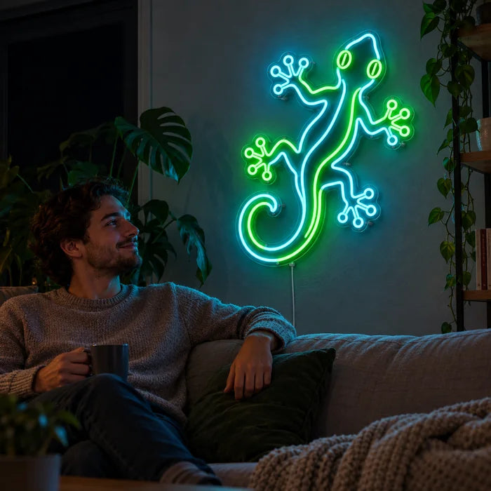 Green Gecko Neon LED Sign on a living room wall, a person relaxing on the sofa in front of it