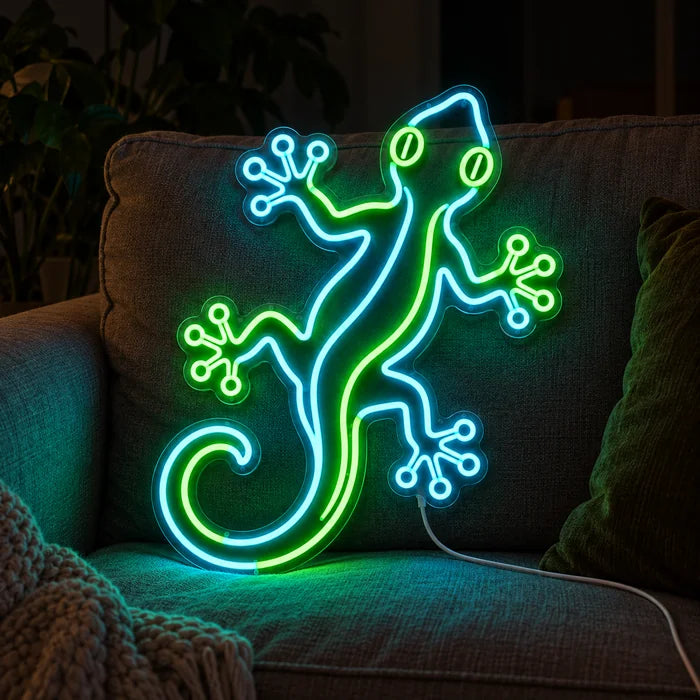Green Gecko Neon LED Sign on a cosy sofa between cushions and a throw