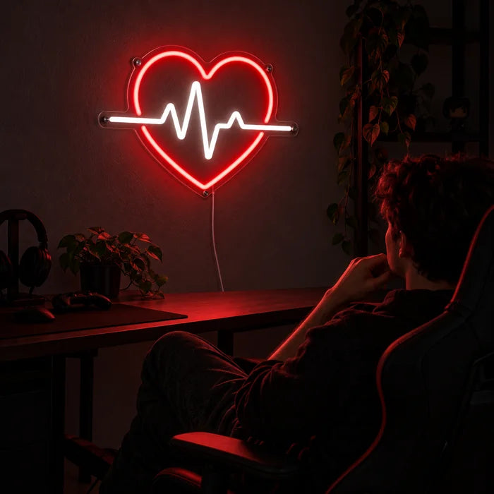 Heartbeat Neon LED Sign above a gaming desk, a gamer in a gaming chair in front of it