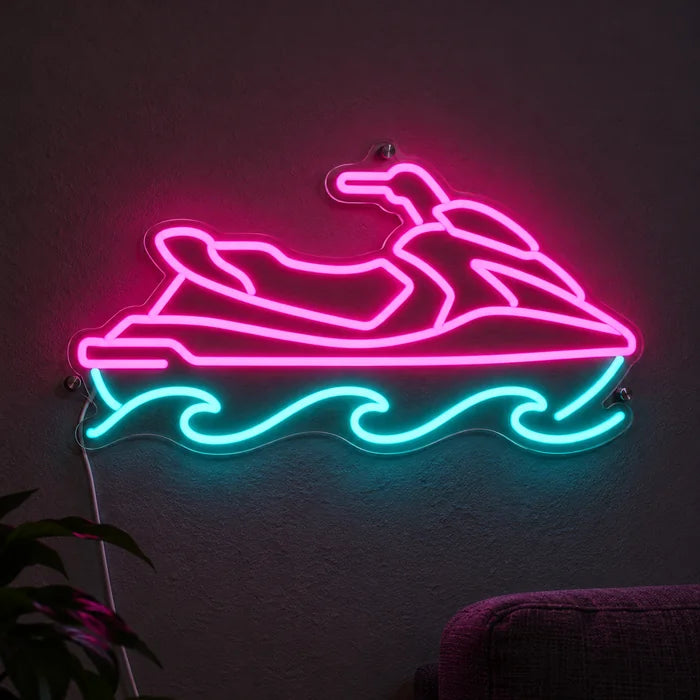 Vesijetti neon LED -kyltti valaistuna tummalla seinällä, lähikuva liitäntäjohdon kanssa