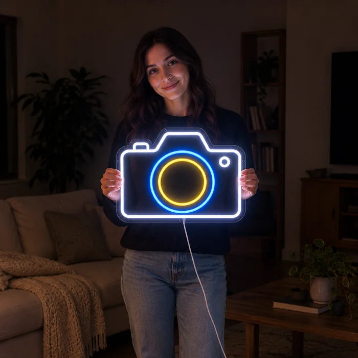 Camera Neon LED Sign held by a woman, showing its size compared to her body