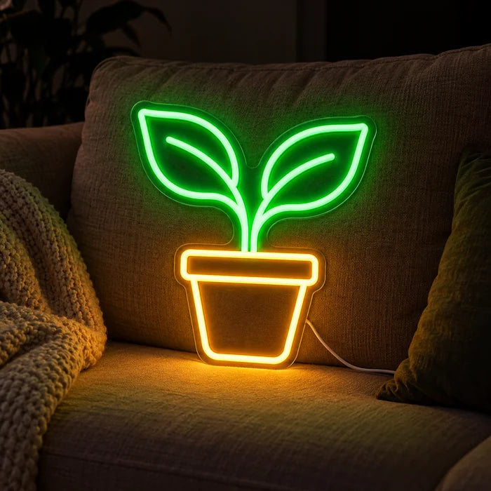 Little Sprout Neon LED Sign on a cosy sofa between cushions and a throw