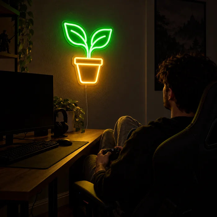 Little Sprout Neon LED Sign above a gaming desk, a gamer in a gaming chair in front of it