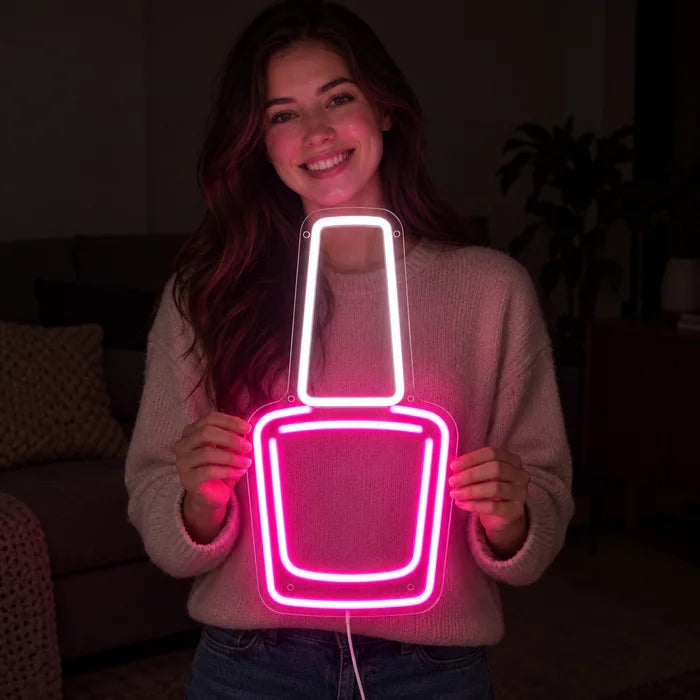 Nail Polish Neon LED Sign held by a smiling woman against a dark background