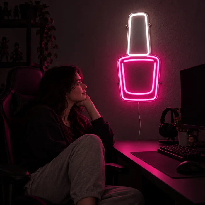 Nail Polish Neon LED Sign above a gaming desk, a gamer in a gaming chair in front of it