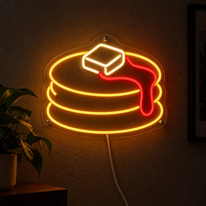 Pancakes Neon LED Sign glowing on a dark wall, close-up with connection cable