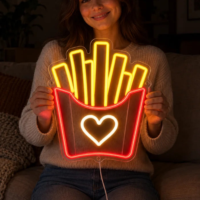 Fries Love Neon LED Sign held by a smiling woman against a dark background