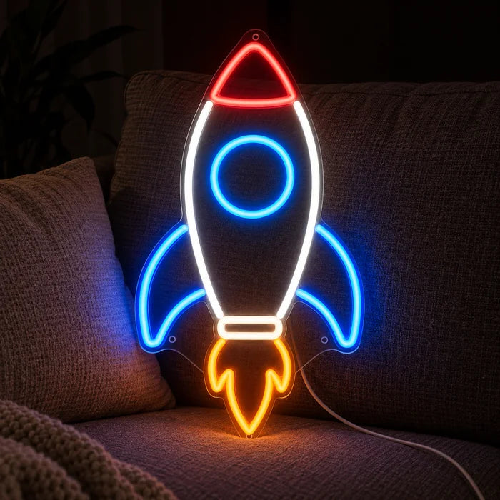 Retro Rocket Neon LED Sign on a cosy sofa between cushions and a throw