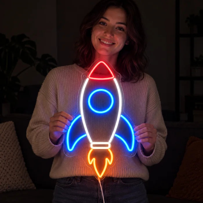 Retro Rocket Neon LED Sign held by a smiling woman against a dark background