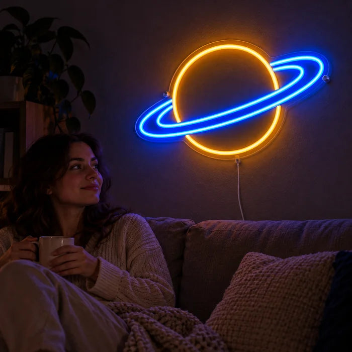 Ringed Planet Neon LED Sign on a living room wall, a person relaxing on the sofa in front of it