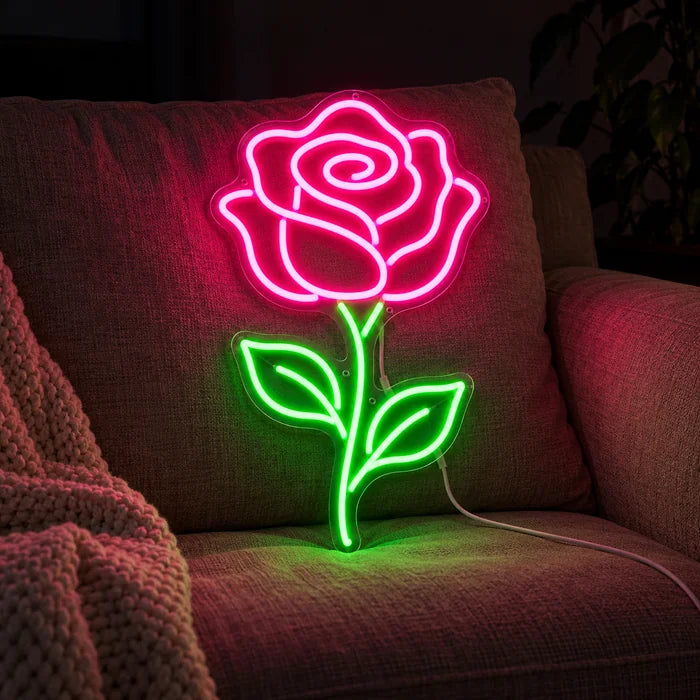 Rose Light Neon LED Sign on a cosy sofa between cushions and a throw