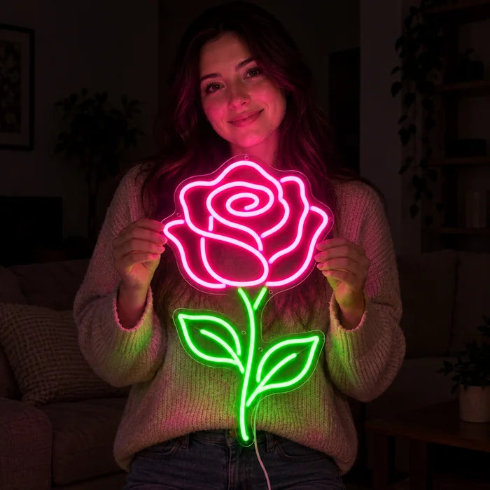 Rose Light Neon LED Sign held by a smiling woman against a dark background