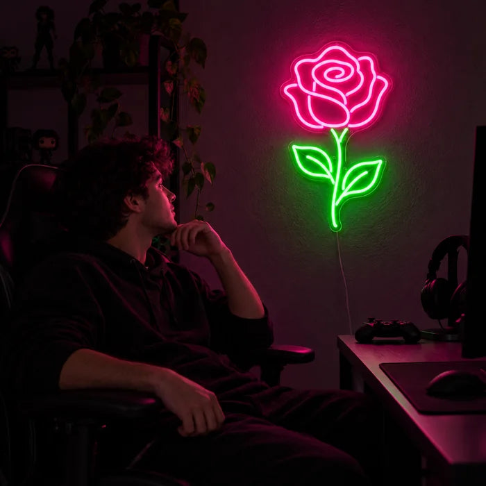 Rose Light Neon LED Sign above a gaming desk, a gamer in a gaming chair in front of it