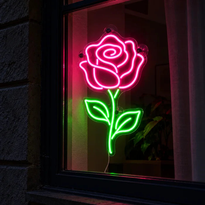 Rose Light Neon LED Sign in a window, seen from the street at night