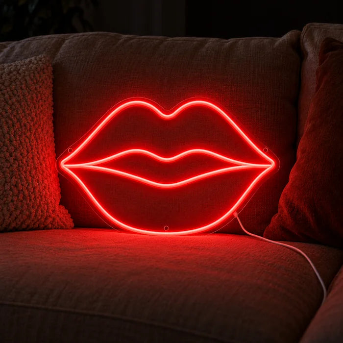 Red Lips Neon LED Sign on a cosy sofa between cushions and a throw