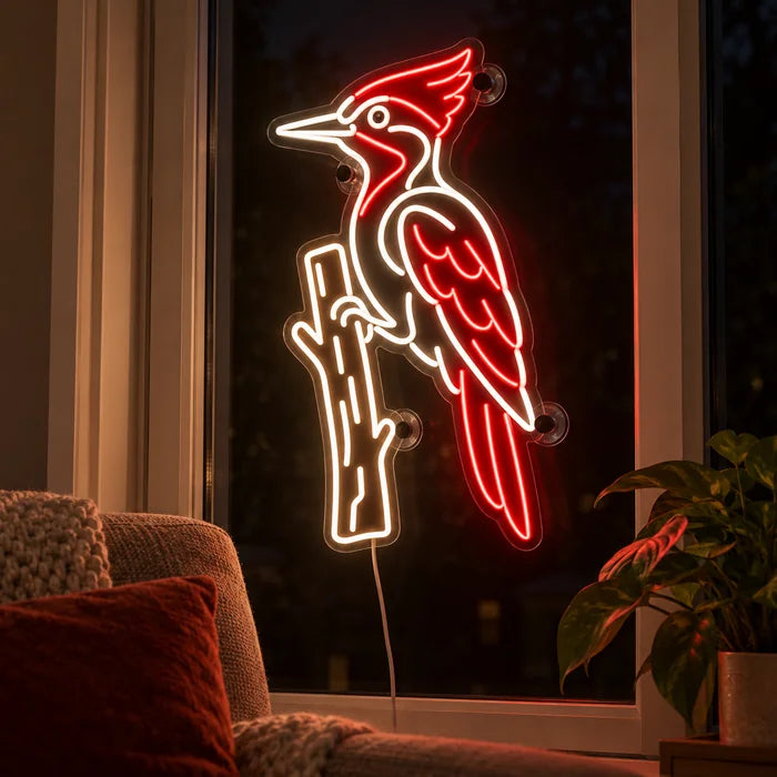 Red Woodpecker Neon LED Sign in the window of a cosy living room in the evening
