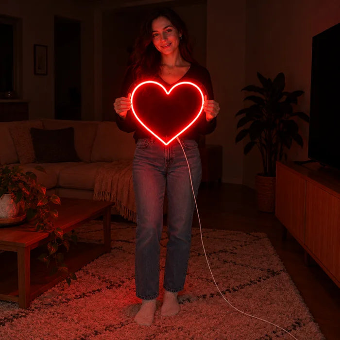 Red Heart Neon LED Sign held by a woman, showing its size compared to her body
