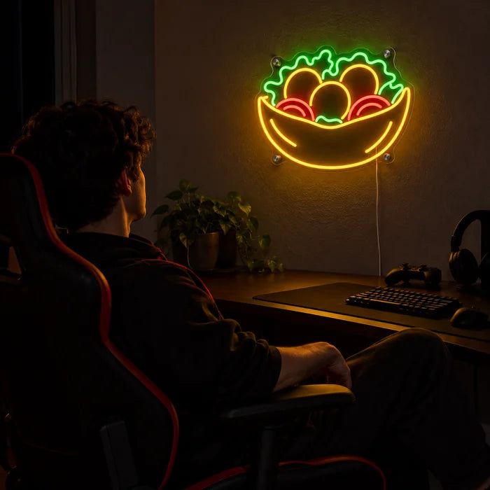 Salad Bowl Neon LED Sign above a gaming desk, a gamer in a gaming chair in front of it