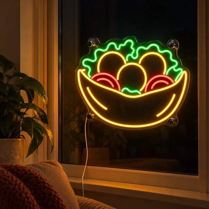 Salad Bowl Neon LED Sign in the window of a cosy living room in the evening