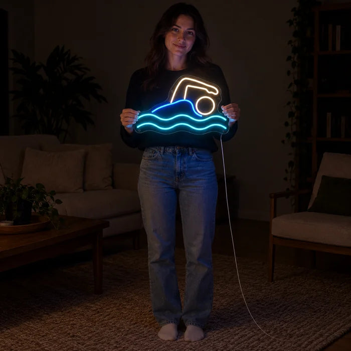 Swimmer Neon LED Sign held by a woman, showing its size compared to her body
