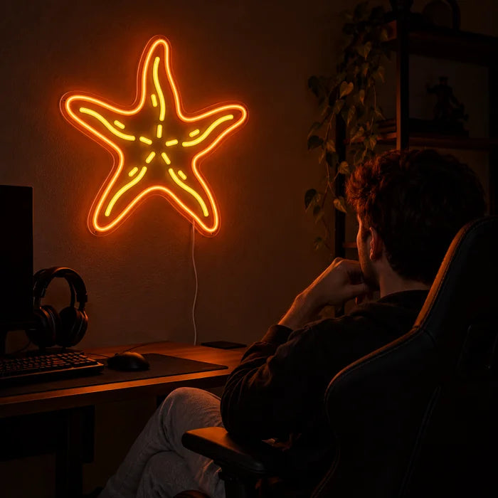 Starfish Neon LED Sign above a gaming desk, a gamer in a gaming chair in front of it