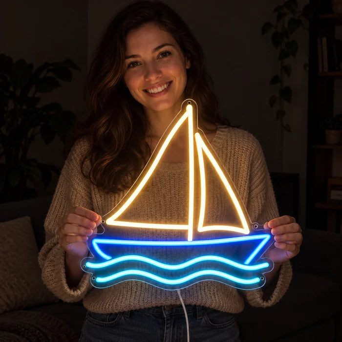 Sailing Boat Neon LED Sign held by a smiling woman against a dark background