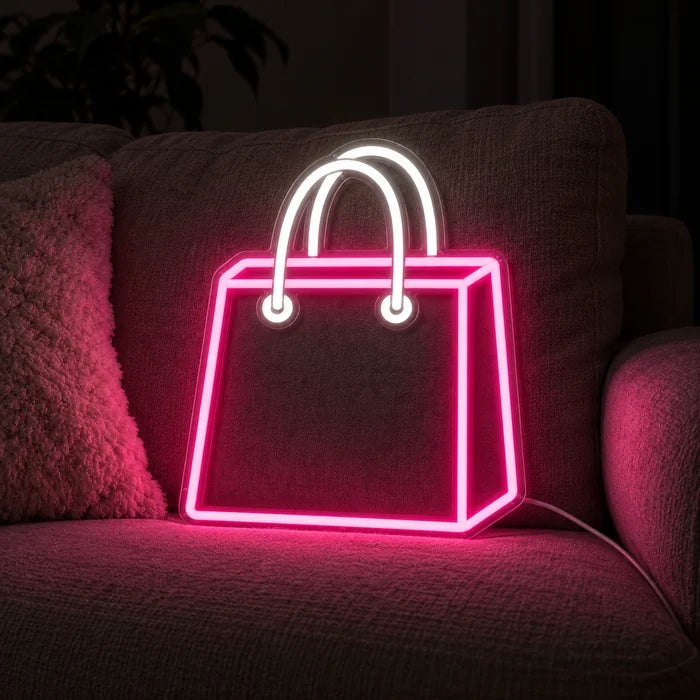 Shopping Bag Neon LED Sign on a cosy sofa between cushions and a throw