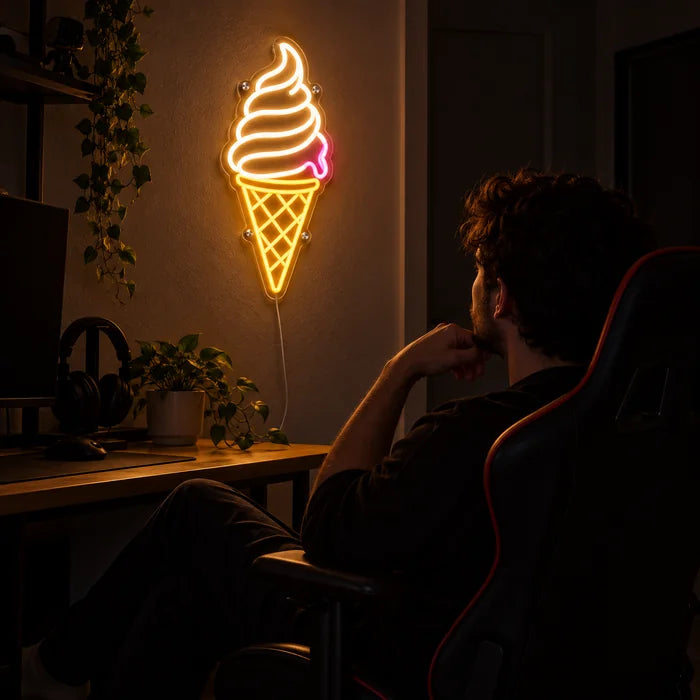 Soft Serve Ice Cream Neon LED Sign above a gaming desk, a gamer in a gaming chair in front of it
