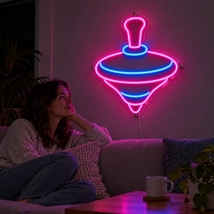 Spinning Top Neon LED Sign on a living room wall, a person relaxing on the sofa in front of it
