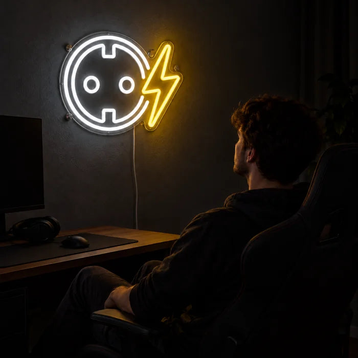 Socket with Lightning Bolt Neon LED Sign above a gaming desk, a gamer in a gaming chair in front of it