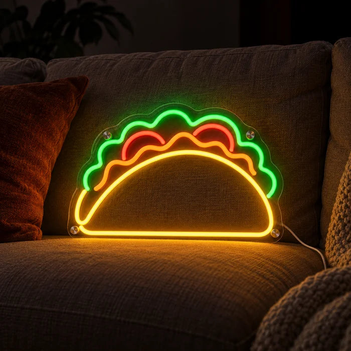 Taco Time Neon LED Sign on a cosy sofa between cushions and a throw