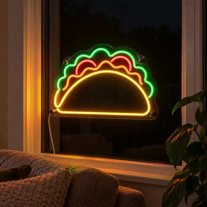 Taco Time Neon LED Sign in the window of a cosy living room in the evening