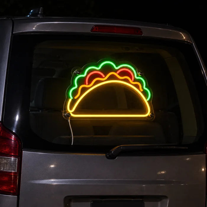 Taco Time Neon LED Sign on the rear window of a car at night