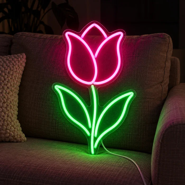 Tulip Neon LED Sign on a cosy sofa between cushions and a throw