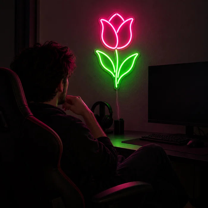 Tulip Neon LED Sign above a gaming desk, a gamer in a gaming chair in front of it
