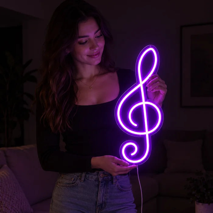 Treble Clef Neon LED Sign held by a woman, showing its size compared to her body
