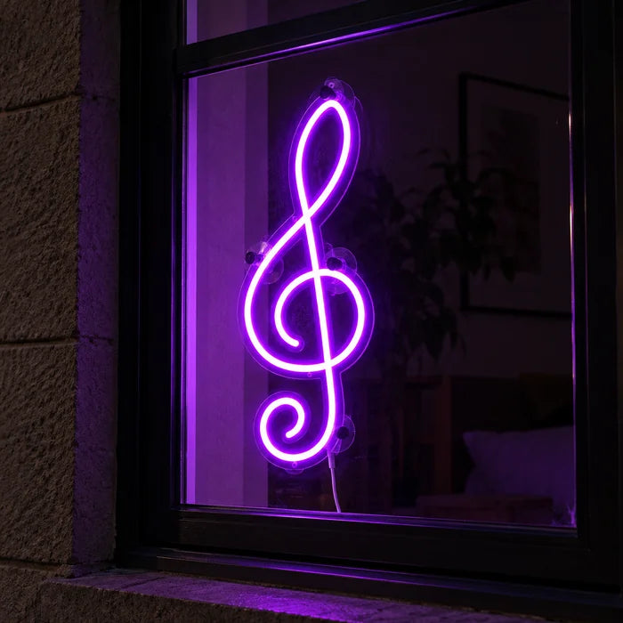 Treble Clef Neon LED Sign in a window, seen from the street at night