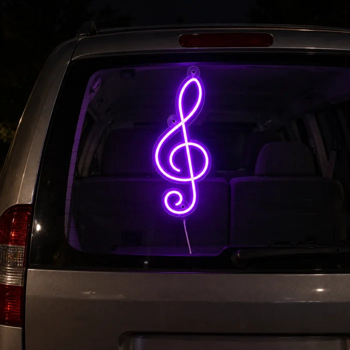 Treble Clef Neon LED Sign on the rear window of a car at night
