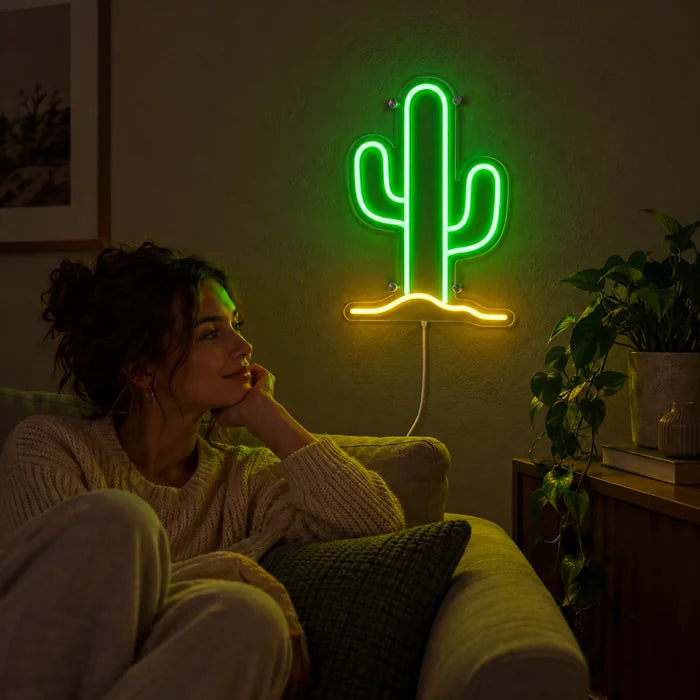 Desert Cactus Neon LED Sign on a living room wall, a person relaxing on the sofa in front of it