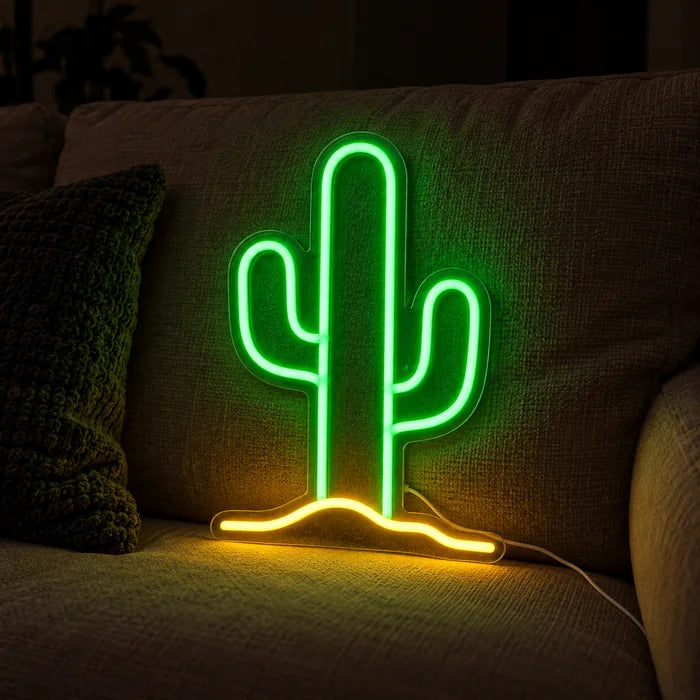 Desert Cactus Neon LED Sign on a cosy sofa between cushions and a throw